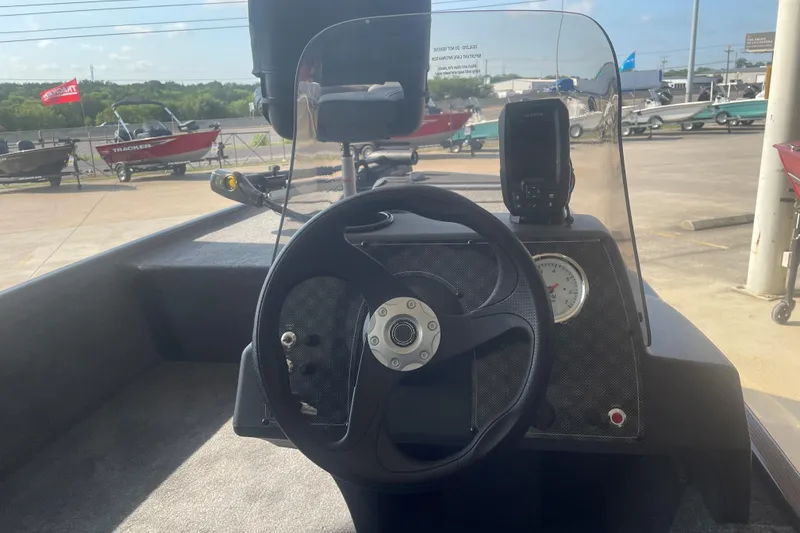 Slide: The Image of 2026 Tracker Bass Tracker Classic XL boat dashboard with steering wheel and gauge. - 8