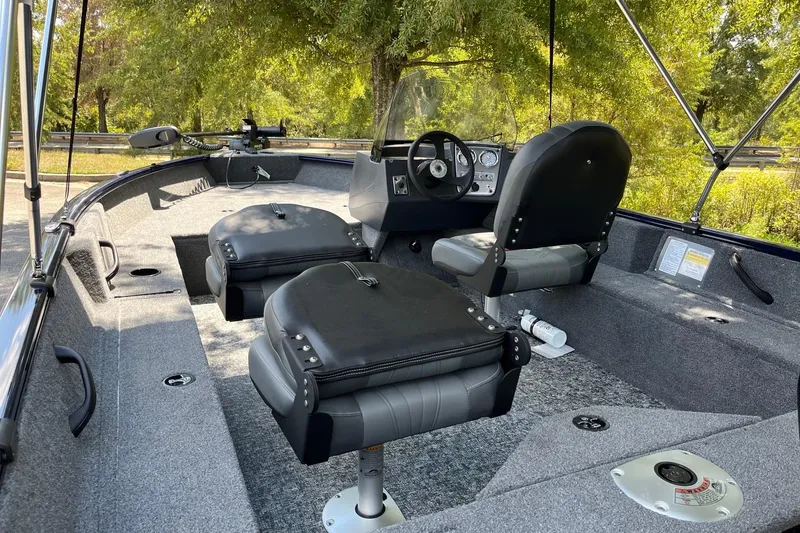 Slide: The Image of 2026 Tracker Pro Guide V-16 SC boat interior with seating and steering console. - 5