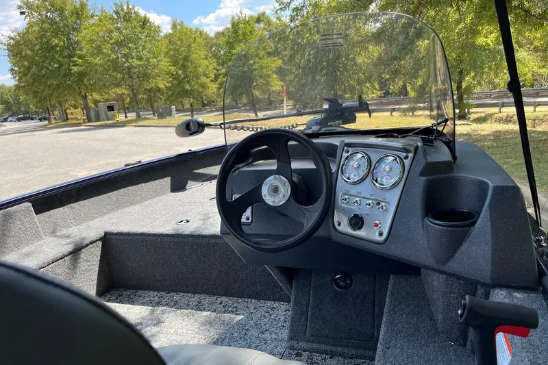 Slide: The Image of 2026 Tracker Pro Guide V-16 SC boat interior with steering wheel and dashboard controls. - 6