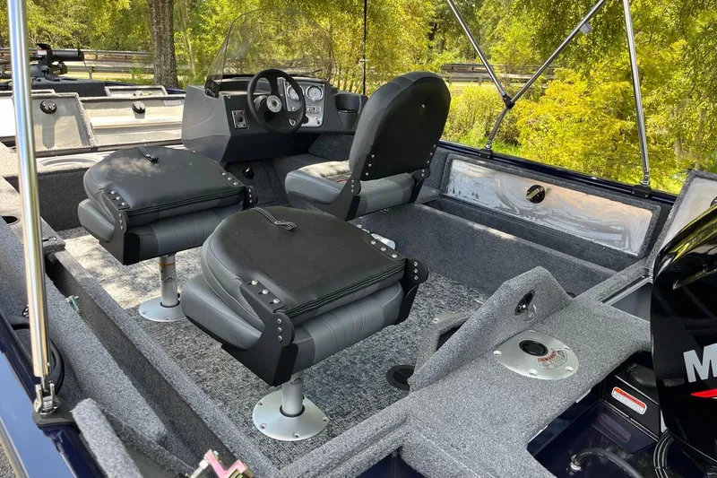 Slide: The Image of 2026 Tracker Pro Guide V-16 SC boat interior with seating and steering console. - 7