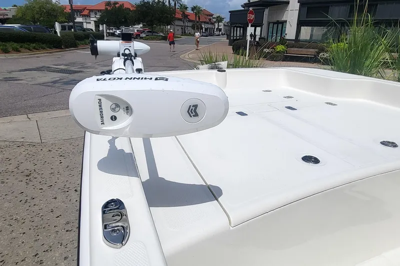 Slide: The Image of 2026 Mako Pro Skiff 15 CC with Minn Kota motor in urban setting. - 1