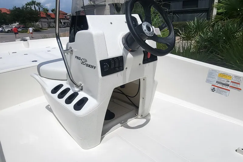 Slide: The Image of 2026 Mako Pro Skiff 15 CC boat console with steering wheel and controls. - 3