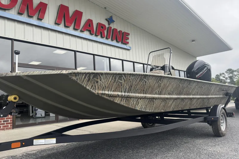 Slide: The Image of 2026 Tracker Grizzly 1860 CC boat on trailer outside marine dealership. - 6