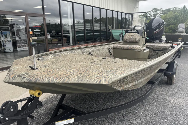 Slide: The Image of 2026 Tracker Grizzly 1860 CC boat with camouflage design on a trailer. - 7