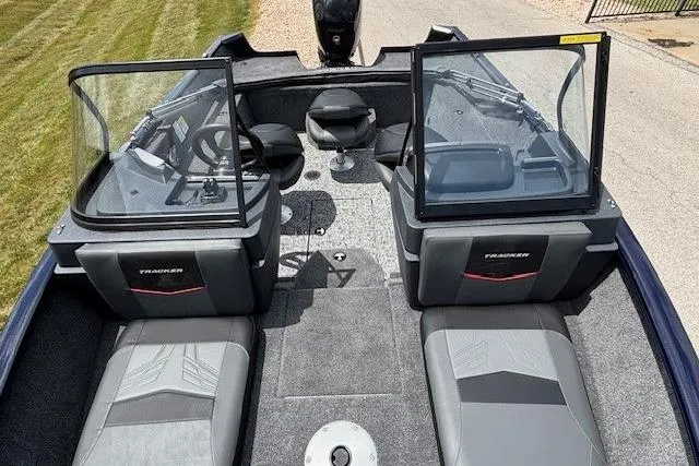 Slide: The Image of 2026 Tracker Pro Guide V-175 WT boat interior with steering wheel and seating. - 2