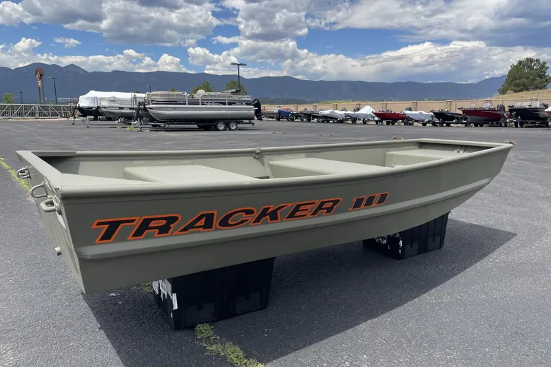 The Image of 2026 Tracker Grizzly 10 Jon boat displayed outdoors with mountains in the background. - 0