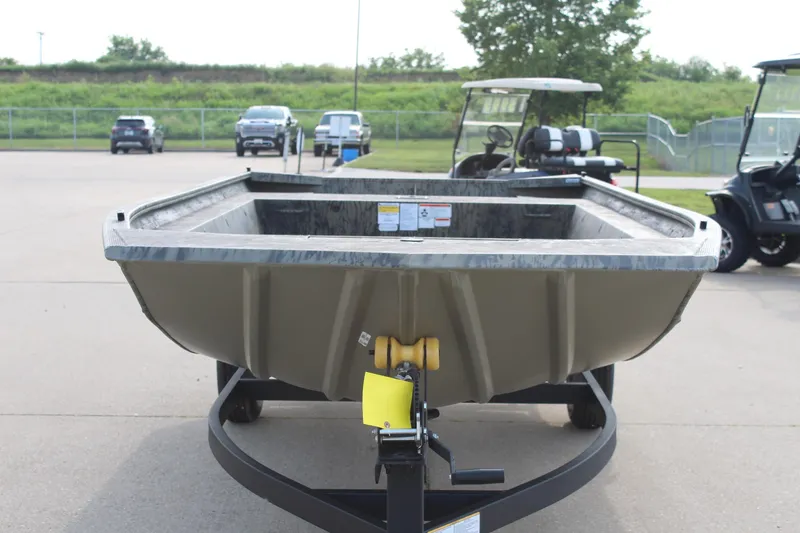 Slide: The Image of 2026 Tracker Grizzly 1754 Utility boat on trailer in parking lot. - 2