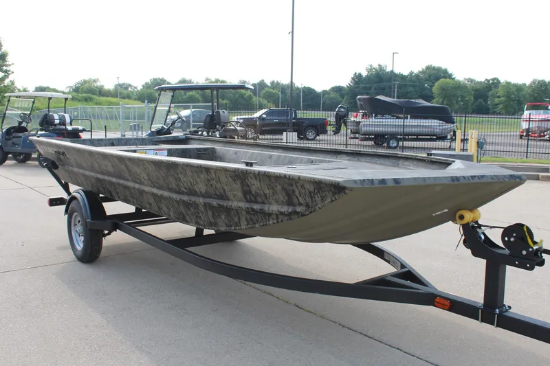 Slide: The Image of 2026 Tracker Grizzly 1754 Utility boat on trailer, parked outdoors. - 3