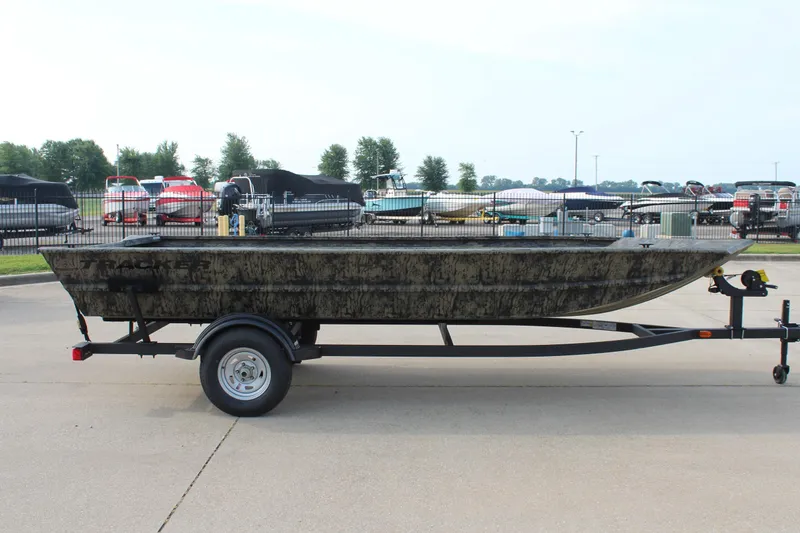 Slide: The Image of 2026 Tracker Grizzly 1754 Utility boat on trailer, parked outdoors. - 4