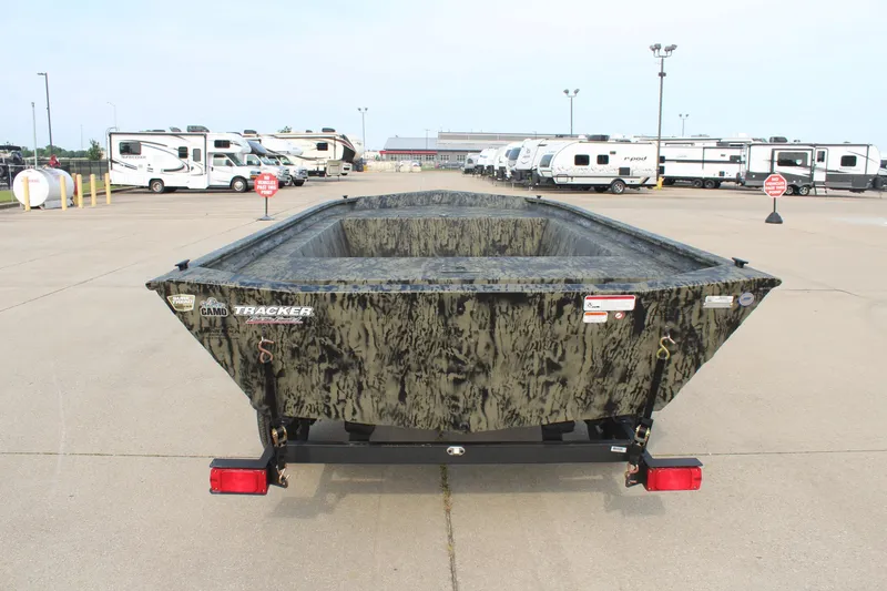 Slide: The Image of 2026 Tracker Grizzly 1754 Utility boat in a parking lot with RVs in the background. - 6