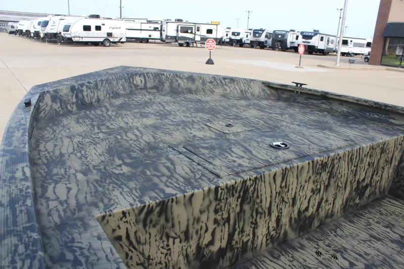 Slide: The Image of 2026 Tracker Grizzly 1754 Utility boat with camouflage design in a parking lot. - 9