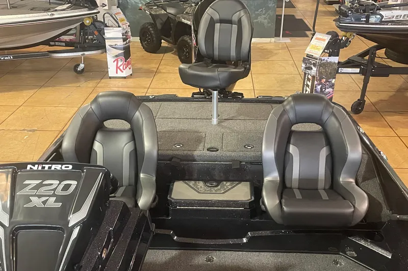 Slide: The Image of 2026 Nitro Z20 XL Pro boat interior with three black seats in showroom. - 9
