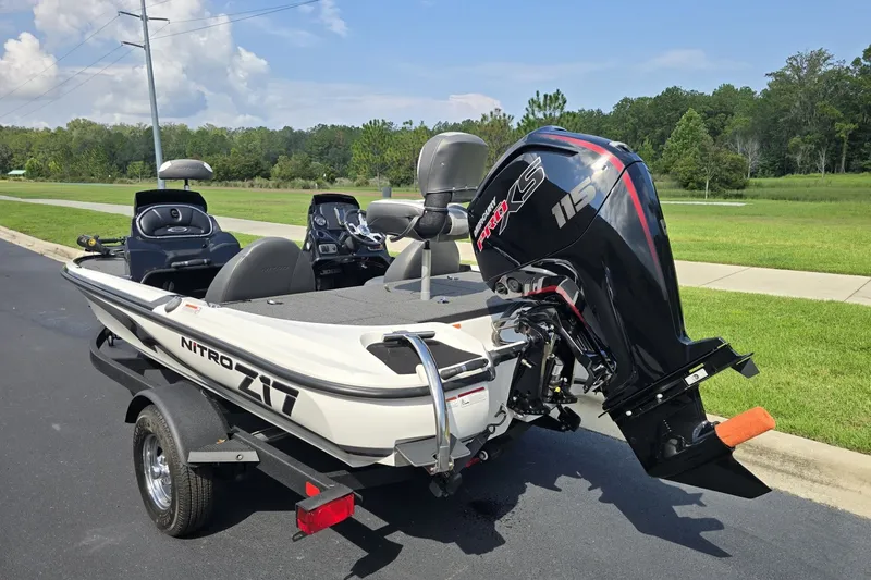 Slide: The Image of 2026 Nitro Z17 boat with powerful outboard motor on a trailer, parked outdoors. - 7