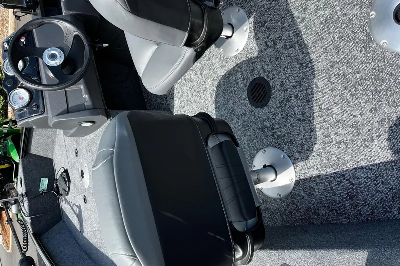 Slide: The Image of Interior of 2026 Tracker Super Guide V-16 SC boat with gray seating and dashboard. - 3