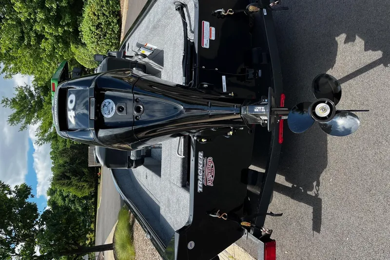 Slide: The Image of 2026 Tracker Super Guide V-16 SC boat with a 40 HP outboard motor, parked on pavement. - 4