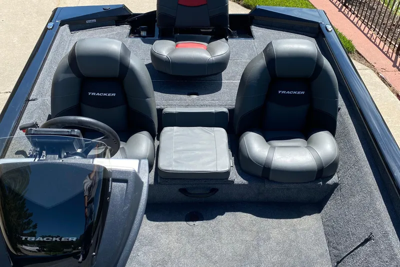 Slide: The Image of 2026 Tracker Pro Team 190 boat interior with gray seating and steering console. - 4