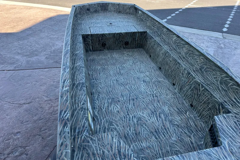 Slide: The Image of 2026 Tracker Grizzly 1650 T Prairie Wings Edition boat with camouflage interior design. - 10