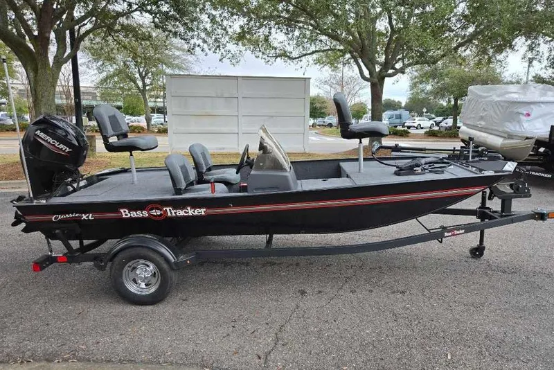 The Image of 2026 Tracker Bass Tracker Classic XL fishing boat on trailer, parked outdoors. - 0