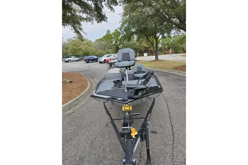 Slide: The Image of 2026 Tracker Bass Tracker Classic XL boat on trailer in parking lot. - 2