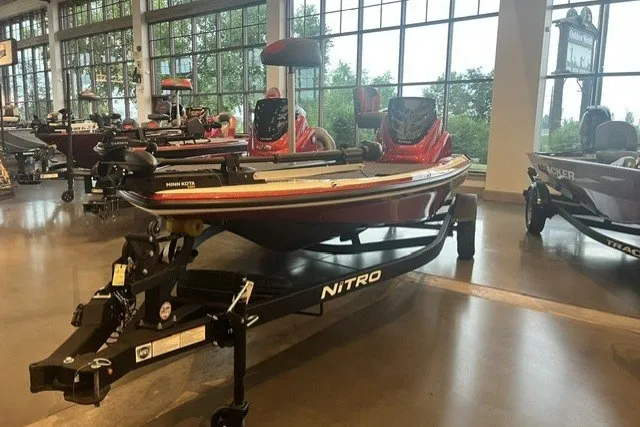 Slide: The Image of 2026 Nitro Z17 boat displayed indoors on a trailer, surrounded by other boats. - 7