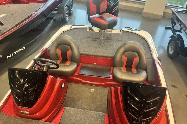 Slide: The Image of 2026 Nitro Z17 boat interior with red and black seating, steering wheel, and dashboard. - 13