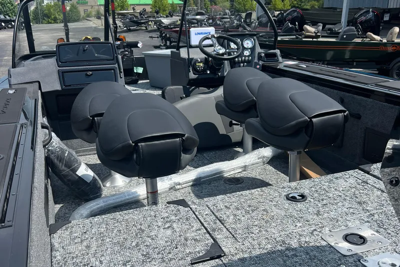 Slide: The Image of 2026 Tracker Targa V-18 Combo boat interior with modern seating and dashboard controls. - 2