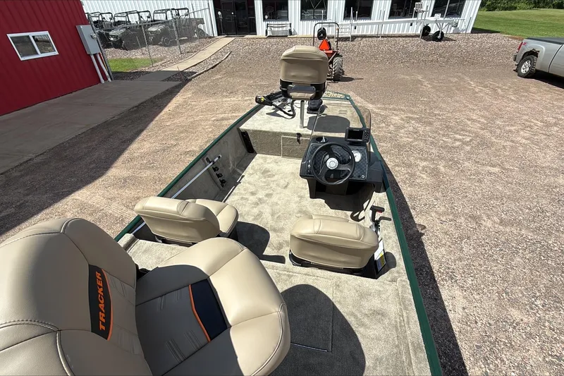 Slide: The Image of 2026 Tracker Bass Tracker Classic Limited boat with beige seats and steering console. - 2