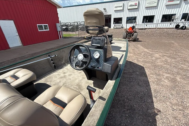 Slide: The Image of 2026 Tracker Bass Tracker Classic Limited boat interior with steering wheel and seats. - 3