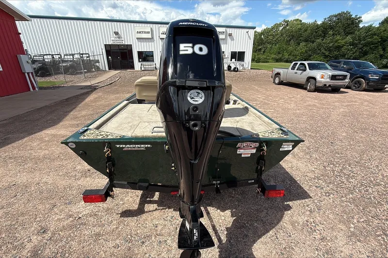 Slide: The Image of 2026 Tracker Bass Tracker Classic Limited boat with Mercury 50 engine in a dealership lot. - 4