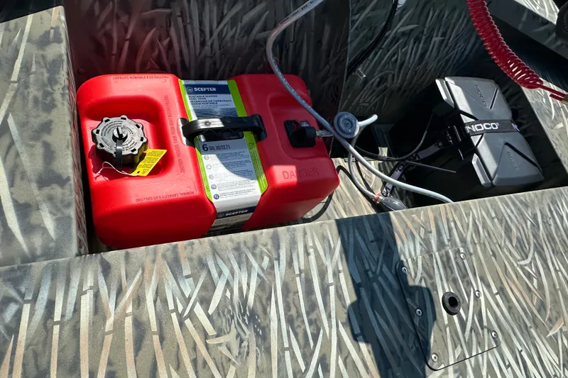 Slide: The Image of 2026 Tracker Grizzly 1648 Utility boat interior with red fuel tank and battery box. - 15