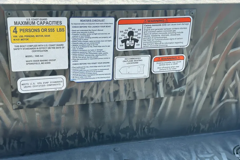 Slide: The Image of Tracker Grizzly 1648 Utility 2026 safety and capacity labels with warnings and checklist. - 16