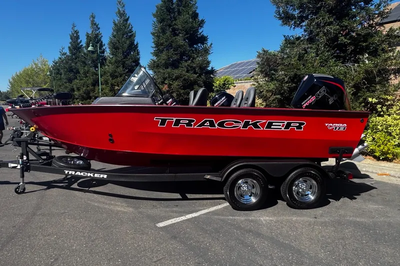The Image of 2026 Tracker Targa V-18 WT boat in vibrant red on a trailer, parked outdoors. - 0