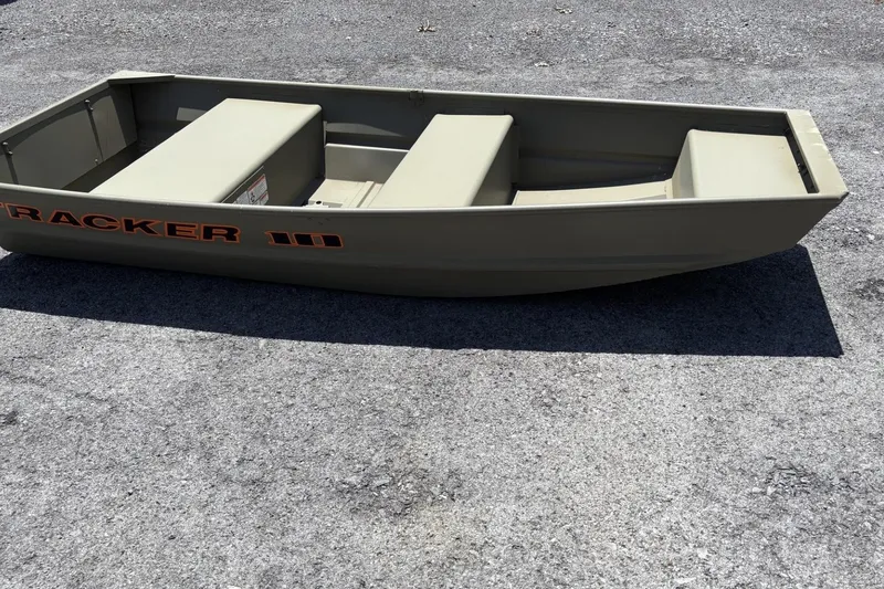 The Image of 2026 Tracker Grizzly 10 Jon boat on pavement, showcasing its compact design and sturdy build. - 0