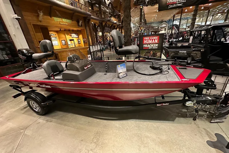 The Image of 2026 Tracker Bass Tracker Classic XL boat displayed indoors, featuring red exterior and modern seating. - 0