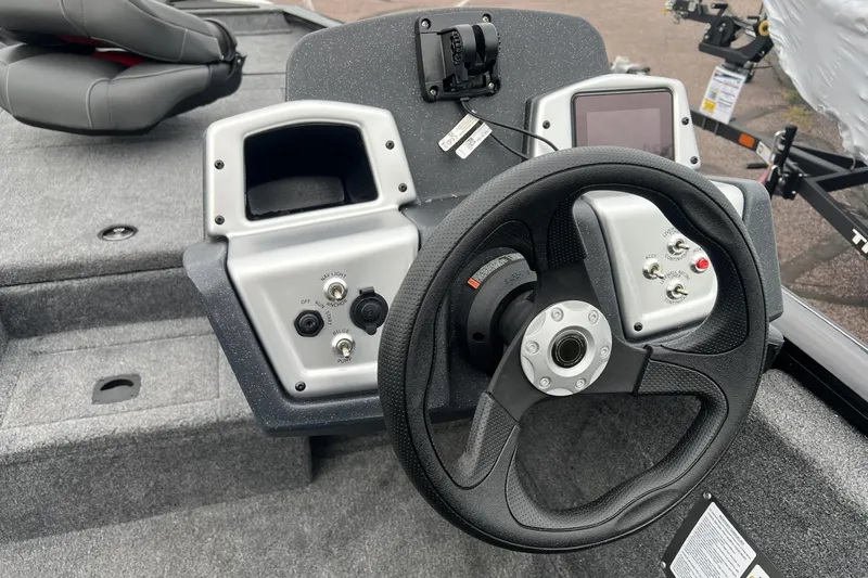 Slide: The Image of 2026 Tracker Pro Team 175 boat dashboard with steering wheel and control panel. - 4