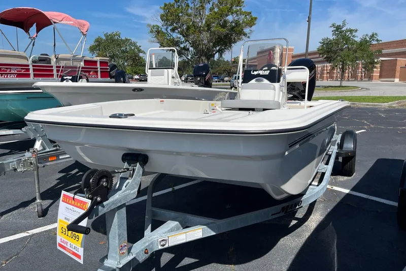 Slide: The Image of 2026 Mako Pro Skiff 17 CC boat on trailer, displayed outdoors, clearance sale sign visible. - 1