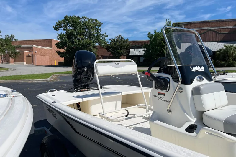 Slide: The Image of 2026 Mako Pro Skiff 17 CC boat with center console in a parking lot. - 7