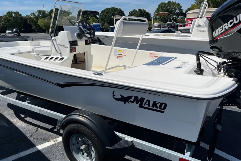Slide: The Image of 2026 Mako Pro Skiff 17 CC boat on trailer, featuring Mercury outboard motor. - 3