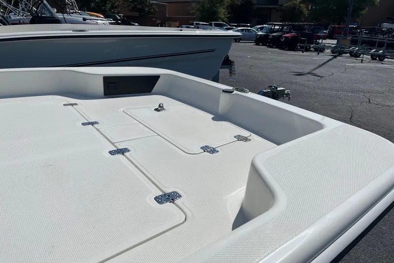 Slide: The Image of 2026 Mako Pro Skiff 17 CC boat deck, featuring storage compartments and sleek design. - 8