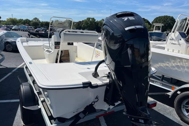 Slide: The Image of 2026 Mako Pro Skiff 17 CC boat with Mercury 75 engine in parking lot. - 4