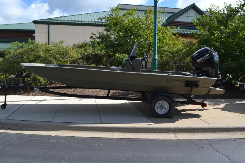 The Image of 2026 Tracker Grizzly 1860 CC boat on trailer, parked outdoors. - 0