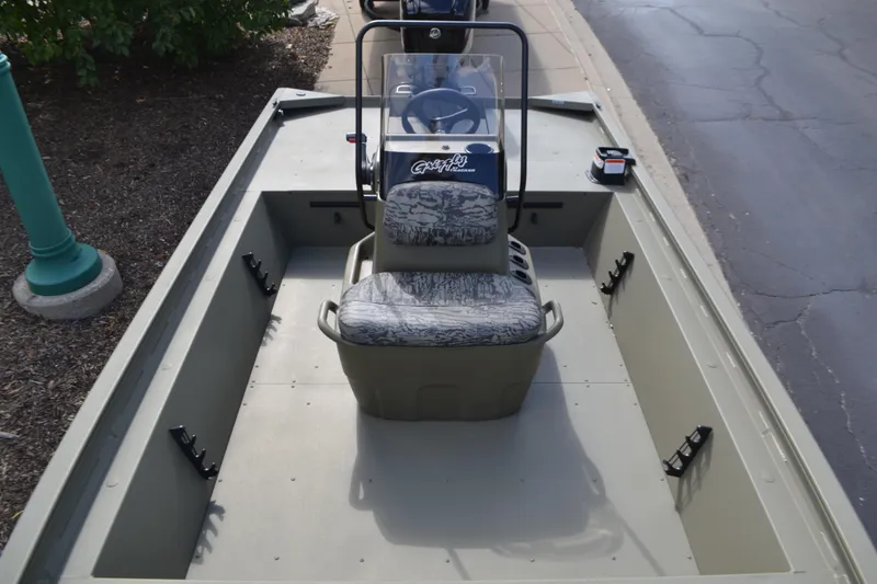 Slide: The Image of 2026 Tracker Grizzly 1860 CC boat interior with central console and seating. - 3