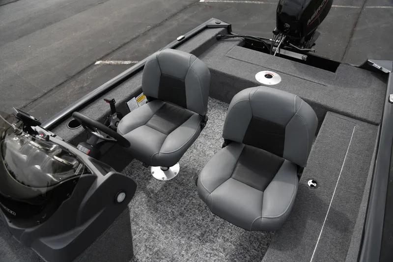 Slide: The Image of 2026 Tracker Super Guide V-16 SC boat interior with two gray seats and steering console. - 3
