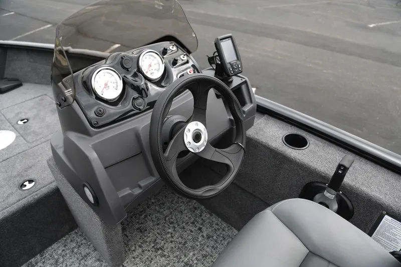 Slide: The Image of Steering console of 2026 Tracker Super Guide V-16 SC boat with gauges and controls. - 4