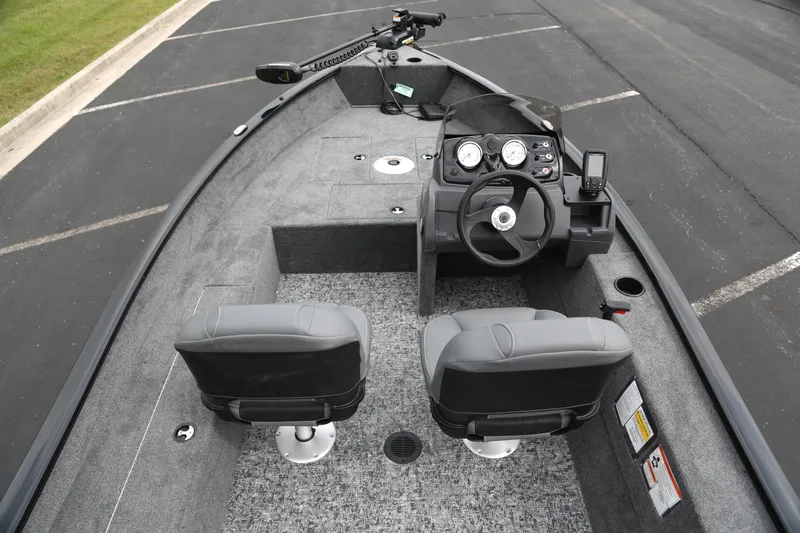 Slide: The Image of 2026 Tracker Super Guide V-16 SC boat interior with steering console and seating. - 5