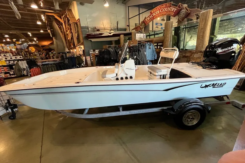 The Image of 2026 Mako Pro Skiff 17 CC boat displayed indoors on a trailer. - 0