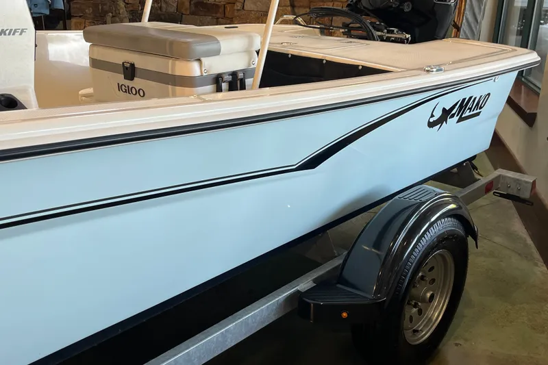 Slide: The Image of 2026 Mako Pro Skiff 17 CC boat on trailer, featuring Igloo cooler and sleek design. - 23