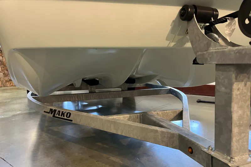 Slide: The Image of 2026 Mako Pro Skiff 17 CC boat on trailer, showcasing hull design. - 25