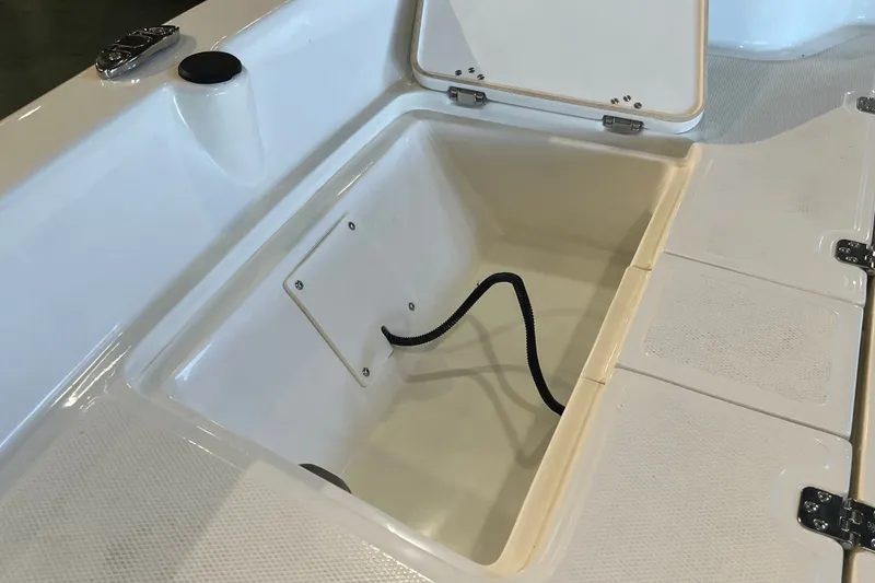 Slide: The Image of Open storage compartment on 2026 Mako Pro Skiff 17 CC boat. - 14