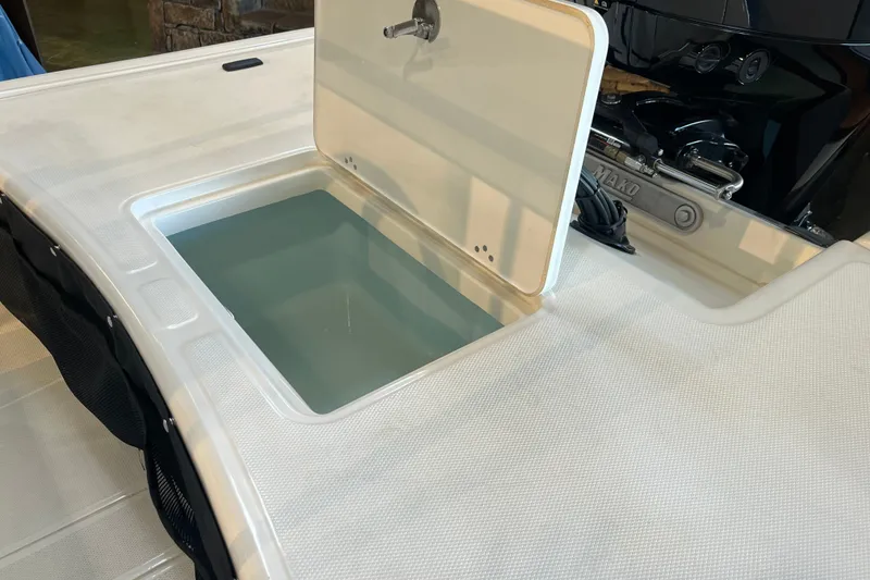 Slide: The Image of Open storage compartment on 2026 Mako Pro Skiff 17 CC boat. - 21